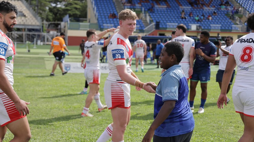 A young fan greets the boys post-game.