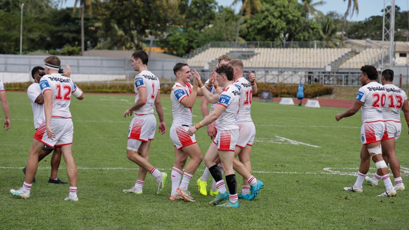 The squad celebrate the opening try of the encounter.