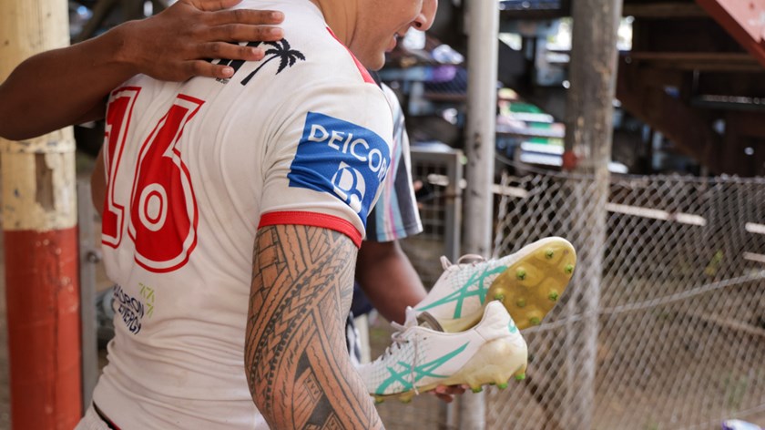 Jett Liu gifts his boots to a local fan.