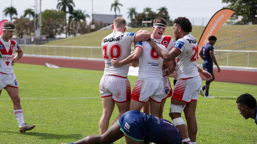 Nick Quinn swarmed by teammates after scoring off his own grubber.