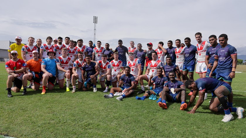 The sides gather for a group shot post-game.