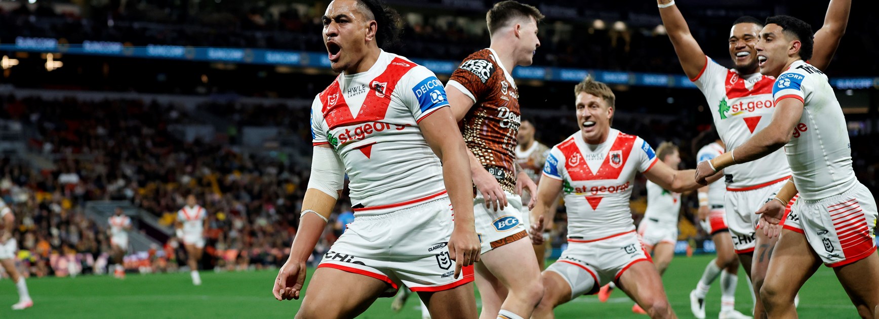 Christian Tuipulotu celebrates a try against the Broncos in round 19.